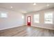 Bright living room featuring recessed lighting, a red entry door and large windows at 122 Weavers Grove Dr, Chapel Hill, NC 27514