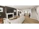 Rendered open-concept living space with a modern fireplace, adjacent kitchen, and staircase at 122 Weavers Grove Dr, Chapel Hill, NC 27514