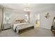 Spacious main bedroom features a decorative headboard, chandelier, and ensuite bathroom access at 1242 Magic Hollow Rd, Durham, NC 27713