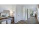 Inviting foyer with a console table and a view into the bright living spaces with beautiful hardwood-style floors at 136 Blue Butterfly Dr, Angier, NC 27501