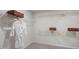 Organized walk-in closet with wire shelving for storage and a white robe at 136 Blue Butterfly Dr, Angier, NC 27501