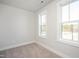 Bright bedroom with natural light that filters in through the two windows, making the room inviting at 138 Weavers Grove Dr # 0118, Chapel Hill, NC 27514