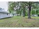 Large backyard with a detached garage and storage shed among mature trees at 1418 Kirkwood Drive Dr, Durham, NC 27705