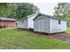 Backyard featuring well-maintained lawn, a detached shed, and the home's exterior at 1418 Kirkwood Drive Dr, Durham, NC 27705