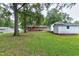 A spacious backyard featuring a brick home, a shed, and lush greenery at 1418 Kirkwood Drive Dr, Durham, NC 27705