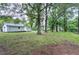 Expansive backyard featuring mature trees, a storage shed, and a detached garage at 1418 Kirkwood Drive Dr, Durham, NC 27705