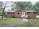 Beautiful front exterior featuring a brick facade, landscaped lawn, and a concrete walkway to the front door at 1418 Kirkwood Drive Dr, Durham, NC 27705