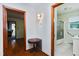 Hallway with hardwood floors leading to bathroom and living spaces at 1418 Kirkwood Drive Dr, Durham, NC 27705