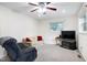 Cozy living room with plush seating, ceiling fan, and window views at 1418 Kirkwood Drive Dr, Durham, NC 27705