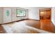 Bright living room featuring hardwood floors, large window for natural light and decorative front door at 1418 Kirkwood Drive Dr, Durham, NC 27705
