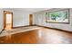 Bright living room featuring hardwood floors, large window for natural light and passage to other room at 1418 Kirkwood Drive Dr, Durham, NC 27705