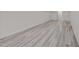 Finished basement area showcasing light gray wood floors and white paint, ready for customization at 1604 Palmer Dr, Graham, NC 27253