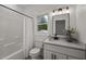 Clean bathroom featuring a bathtub, shower, toilet, vanity, and window, offering a functional design at 1604 Palmer Dr, Graham, NC 27253