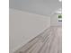 Bright bedroom with light gray wood flooring, a window, and white walls and ceilings at 1604 Palmer Dr, Graham, NC 27253