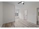 Bright bedroom with a ceiling fan, white walls, and wood-look flooring at 1604 Palmer Dr, Graham, NC 27253