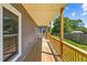 Covered wooden deck offers a relaxing outdoor space with views of the lush backyard at 1604 Palmer Dr, Graham, NC 27253