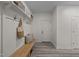 Inviting entryway with a wooden bench, coat hooks, and stylish decor at 1604 Palmer Dr, Graham, NC 27253