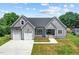 Charming single-Gathering home boasts a two-car garage, welcoming front porch, and a well-manicured lawn at 1604 Palmer Dr, Graham, NC 27253
