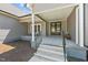 Inviting front porch features stylish seating and a covered entrance with elegant double doors at 1604 Palmer Dr, Graham, NC 27253