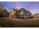 A lovely home with a screened in porch and large yard under a beautiful, colorful sky at 1636 Sweetwater Ln, Raleigh, NC 27610
