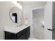 Stylish bathroom featuring a round mirror, sleek vanity, and modern fixtures at 1636 Sweetwater Ln, Raleigh, NC 27610