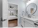 Bathroom featuring a modern vanity and mirror with a view into the bedroom at 1636 Sweetwater Ln, Raleigh, NC 27610