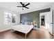 Spacious bedroom with a white iron bed, a decorative accent wall, and natural light at 1636 Sweetwater Ln, Raleigh, NC 27610