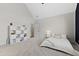 Bedroom with vaulted ceilings, carpeted floors, and a white shelving unit against the wall at 1636 Sweetwater Ln, Raleigh, NC 27610