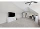 Large bonus room featuring sloped ceilings, a tv and a cozy seating area at 1636 Sweetwater Ln, Raleigh, NC 27610