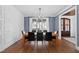 Formal dining room with wainscoting, a modern chandelier, and hardwood floors adjacent to the entry at 1636 Sweetwater Ln, Raleigh, NC 27610