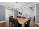 Open-concept dining room with a modern light, seamlessly connecting to a cozy living area at 1636 Sweetwater Ln, Raleigh, NC 27610