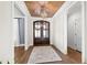 Elegant foyer featuring a wood-paneled ceiling, stylish light fixture, and attractive double front doors at 1636 Sweetwater Ln, Raleigh, NC 27610