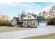 Charming exterior view of the home with stone accents, manicured lawn, and inviting front porch at 1636 Sweetwater Ln, Raleigh, NC 27610