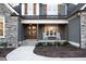 Inviting front porch with a double-door entrance, complemented by rocking chairs and meticulous landscaping at 1636 Sweetwater Ln, Raleigh, NC 27610