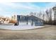 Three car garage and driveway, featuring ample parking and an exterior door to the home at 1636 Sweetwater Ln, Raleigh, NC 27610