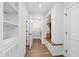 Inviting hallway with built-in storage bench and coat rack, blending style with functionality at 1636 Sweetwater Ln, Raleigh, NC 27610