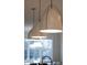Kitchen island lighting with three pendant lamps with brass trim at 1636 Sweetwater Ln, Raleigh, NC 27610