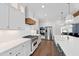 Modern kitchen boasts white cabinets, grey island, and professional-grade appliances at 1636 Sweetwater Ln, Raleigh, NC 27610
