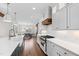 Kitchen with white cabinetry, quartz counters, and a view to the breakfast nook at 1636 Sweetwater Ln, Raleigh, NC 27610