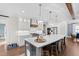 Bright kitchen boasts white cabinetry, gray island, stainless appliances and hardwood floors at 1636 Sweetwater Ln, Raleigh, NC 27610