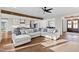 Spacious living room with hardwood floors, a comfortable sectional sofa, and an open flow to the kitchen at 1636 Sweetwater Ln, Raleigh, NC 27610