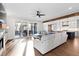 Bright living room showcasing hardwood floors, a stylish sofa, and access to the outdoor deck at 1636 Sweetwater Ln, Raleigh, NC 27610