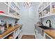 Well-organized pantry with white cabinets, wood countertops, sink and modern lighting at 1636 Sweetwater Ln, Raleigh, NC 27610