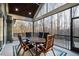Inviting screened porch with vaulted ceiling, dining set, and views of the surrounding woods at 1636 Sweetwater Ln, Raleigh, NC 27610