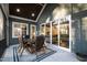 Inviting screened porch with outdoor dining set and view into the well-lit living room at 1636 Sweetwater Ln, Raleigh, NC 27610