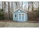 Well-maintained shed with ample storage space and coordinating paint scheme to match home at 1636 Sweetwater Ln, Raleigh, NC 27610