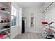 Bright walk-in closet with built-in shelving, hanging rods, and large window for natural light at 1636 Sweetwater Ln, Raleigh, NC 27610