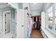 Organized walk-in closet featuring custom shelving, natural light from a window, and a hardwood floor at 1636 Sweetwater Ln, Raleigh, NC 27610