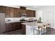Modern kitchen featuring stainless steel appliances, granite countertops, and dark wood cabinets at 174 Blue Butterfly Dr, Angier, NC 27501