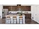 Modern kitchen featuring stainless steel appliances, granite countertops, and dark wood cabinets at 174 Blue Butterfly Dr, Angier, NC 27501